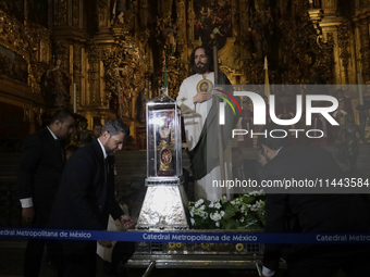 A group of people is arranging relics of St. Jude Thaddeus inside the Metropolitan Cathedral in Mexico City, Mexico, a work being carried ou...