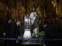 A group of people is arranging relics of St. Jude Thaddeus inside the Metropolitan Cathedral in Mexico City, Mexico, a work being carried ou...