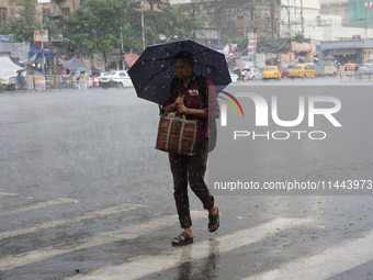 A man is walking on a road during heavy monsoon rain in Kolkata, eastern India, on July 30, 2024. (