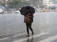 A man is walking on a road during heavy monsoon rain in Kolkata, eastern India, on July 30, 2024. (