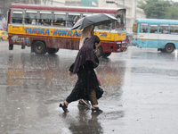 Women are crossing a road during heavy monsoon rain in Kolkata, India, on July 30, 2024. (