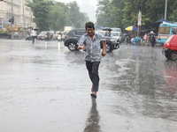 A man is crossing a road during heavy monsoon rain in Kolkata, India, on July 30, 2024. (