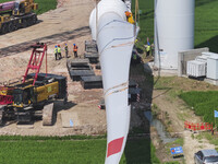 Workers are installing wind power equipment at Henggou village in Huai'an city, East China's Jiangsu province, on July 30, 2024. (