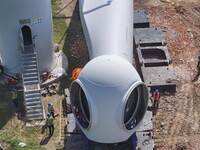 Workers are installing wind power equipment at Henggou village in Huai'an city, East China's Jiangsu province, on July 30, 2024. (