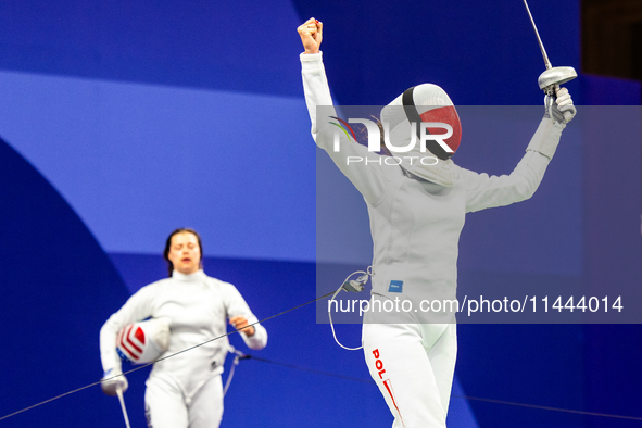 Martyna Swatowska-Wenglarczyk of Team Poland and Hadley Husisian of Team United States compete during the Women's Epee Team Table of 8 match...