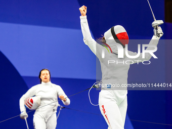 Martyna Swatowska-Wenglarczyk of Team Poland and Hadley Husisian of Team United States compete during the Women's Epee Team Table of 8 match...