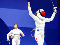 Martyna Swatowska-Wenglarczyk of Team Poland and Hadley Husisian of Team United States compete during the Women's Epee Team Table of 8 match...