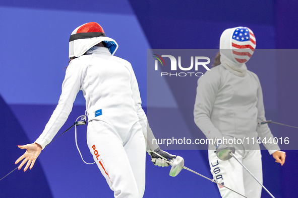 Martyna Swatowska-Wenglarczyk of Team Poland and Hadley Husisian of Team United States compete during the Women's Epee Team Table of 8 match...