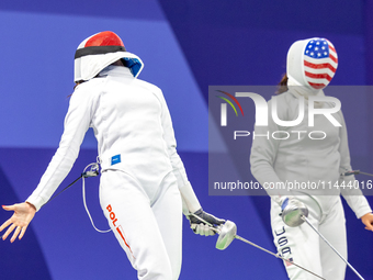 Martyna Swatowska-Wenglarczyk of Team Poland and Hadley Husisian of Team United States compete during the Women's Epee Team Table of 8 match...