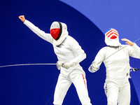 Martyna Swatowska-Wenglarczyk of Team Poland and Hadley Husisian of Team United States compete during the Women's Epee Team Table of 8 match...