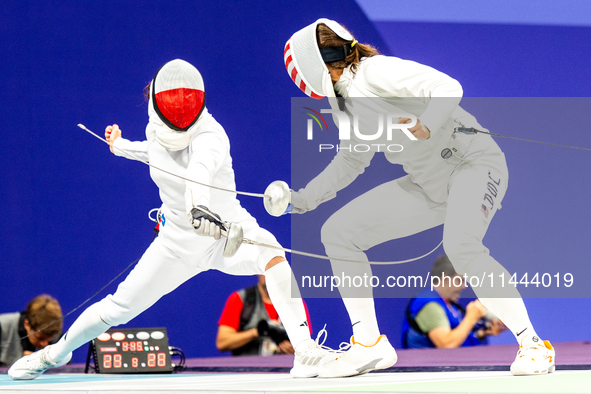 Martyna Swatowska-Wenglarczyk of Team Poland and Hadley Husisian of Team United States compete during the Women's Epee Team Table of 8 match...