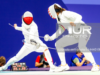 Martyna Swatowska-Wenglarczyk of Team Poland and Hadley Husisian of Team United States compete during the Women's Epee Team Table of 8 match...