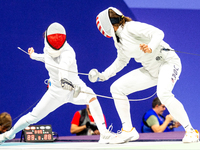 Martyna Swatowska-Wenglarczyk of Team Poland and Hadley Husisian of Team United States compete during the Women's Epee Team Table of 8 match...