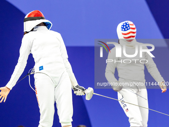 Martyna Swatowska-Wenglarczyk of Team Poland and Hadley Husisian of Team United States compete during the Women's Epee Team Table of 8 match...