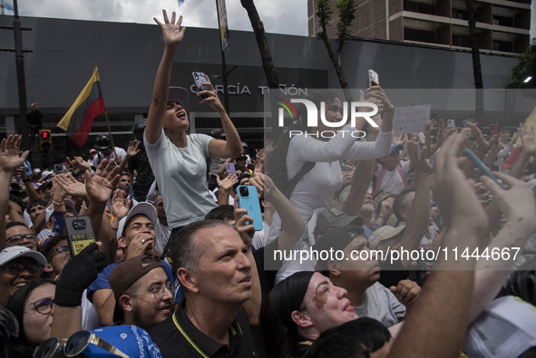 Opponents of Venezuelan President Nicolas Maduro are displaying a Venezuelan flag during a rally called by presidential candidate Edmundo Go...