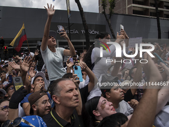 Opponents of Venezuelan President Nicolas Maduro are displaying a Venezuelan flag during a rally called by presidential candidate Edmundo Go...