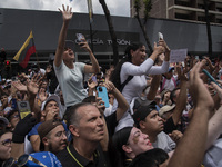 Opponents of Venezuelan President Nicolas Maduro are displaying a Venezuelan flag during a rally called by presidential candidate Edmundo Go...