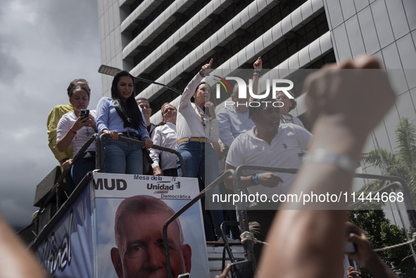 Opponents of Venezuelan President Nicolas Maduro are displaying a Venezuelan flag during a rally called by presidential candidate Edmundo Go...