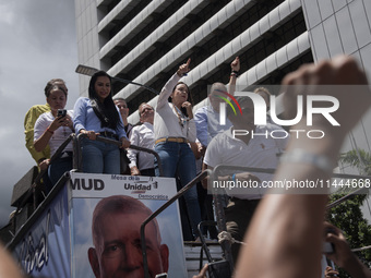 Opponents of Venezuelan President Nicolas Maduro are displaying a Venezuelan flag during a rally called by presidential candidate Edmundo Go...