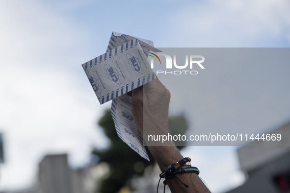 Opponents of Venezuelan President Nicolas Maduro are displaying a Venezuelan flag during a rally called by presidential candidate Edmundo Go...