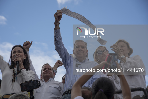 Opponents of Venezuelan President Nicolas Maduro are displaying a Venezuelan flag during a rally called by presidential candidate Edmundo Go...