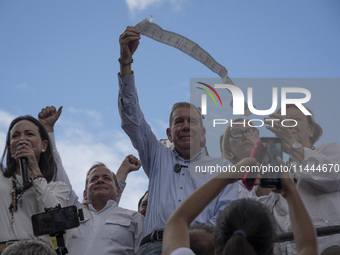 Opponents of Venezuelan President Nicolas Maduro are displaying a Venezuelan flag during a rally called by presidential candidate Edmundo Go...