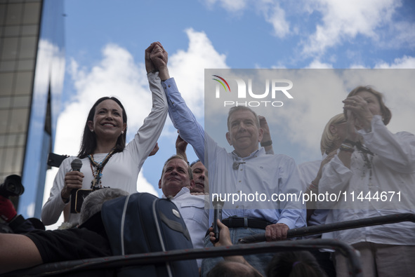 Opponents of Venezuelan President Nicolas Maduro are displaying a Venezuelan flag during a rally called by presidential candidate Edmundo Go...