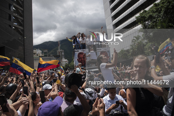 Opponents of Venezuelan President Nicolas Maduro are displaying a Venezuelan flag during a rally called by presidential candidate Edmundo Go...