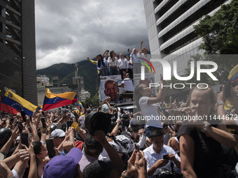 Opponents of Venezuelan President Nicolas Maduro are displaying a Venezuelan flag during a rally called by presidential candidate Edmundo Go...