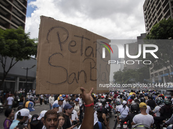 Opponents of Venezuelan President Nicolas Maduro are displaying a Venezuelan flag during a rally called by presidential candidate Edmundo Go...