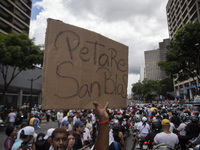 Opponents of Venezuelan President Nicolas Maduro are displaying a Venezuelan flag during a rally called by presidential candidate Edmundo Go...