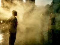 People are cooling off and enjoying a water spray as temperatures rise in Paris, France, on July 30, 2024, during the Paris 2024 Olympic Gam...