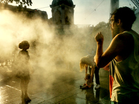 People are cooling off and enjoying a water spray as temperatures rise in Paris, France, on July 30, 2024, during the Paris 2024 Olympic Gam...