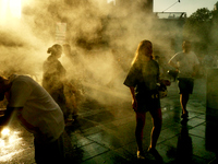 People are cooling off and enjoying a water spray as temperatures rise in Paris, France, on July 30, 2024, during the Paris 2024 Olympic Gam...