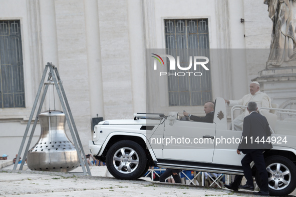 Pope Francis is arriving in St. Peter's Square to meet with priests and altar servers at the Vatican, on July 30, 2024. 