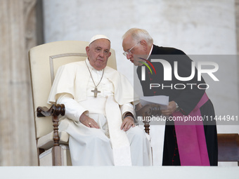 Pope Francis is talking with Padre Leonardo Sapienza during an open-air audience of the XIII International Pilgrimage of Altar Servers at St...