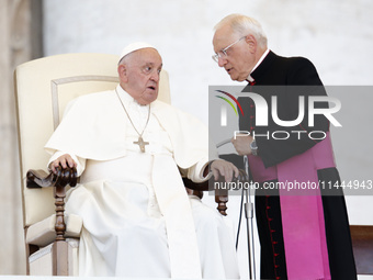 Pope Francis is talking with Padre Leonardo Sapienza during an open-air audience of the XIII International Pilgrimage of Altar Servers at St...