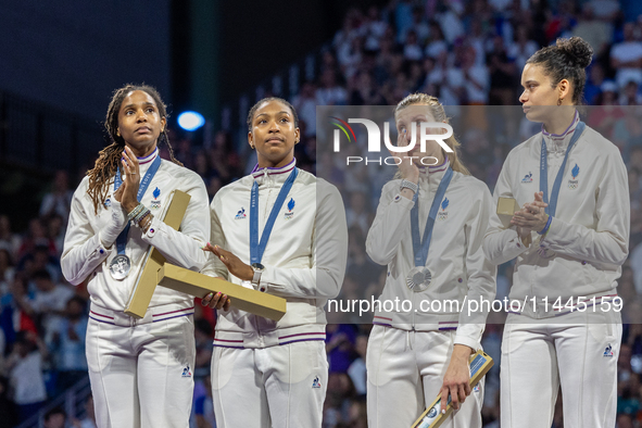 Silver medalists of Team France celebrate on the podium during the Fencing Women's Epee medal ceremony on day four of the Olympic Games Pari...