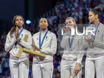 Silver medalists of Team France celebrate on the podium during the Fencing Women's Epee medal ceremony on day four of the Olympic Games Pari...