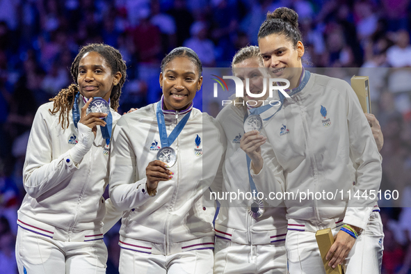 Silver medalists of Team France celebrate on the podium during the Fencing Women's Epee medal ceremony on day four of the Olympic Games Pari...