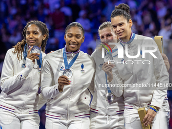 Silver medalists of Team France celebrate on the podium during the Fencing Women's Epee medal ceremony on day four of the Olympic Games Pari...