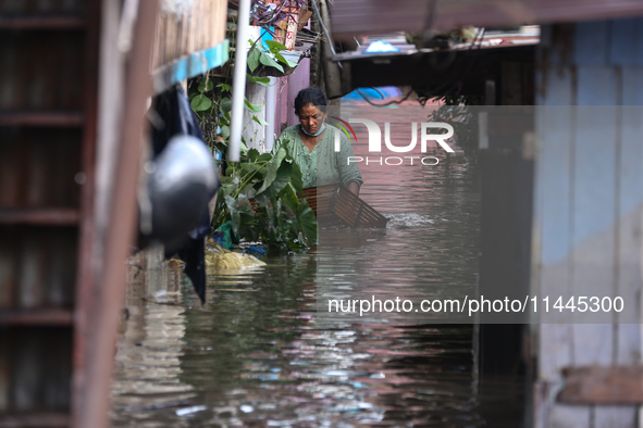 Residents of Kathmandu are wading through the floodwater along the embankment of the Bagmati River flowing through the capital after incessa...