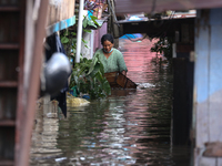 Residents of Kathmandu are wading through the floodwater along the embankment of the Bagmati River flowing through the capital after incessa...