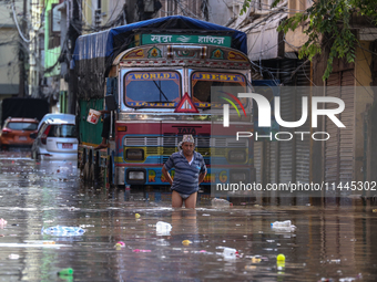 Residents of Kathmandu are wading through the floodwater along the embankment of the Bagmati River flowing through the capital after incessa...