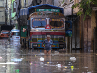 Residents of Kathmandu are wading through the floodwater along the embankment of the Bagmati River flowing through the capital after incessa...