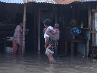 Residents of Kathmandu are wading through the floodwater along the embankment of the Bagmati River flowing through the capital after incessa...