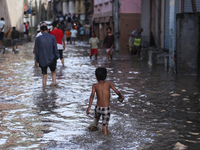 Residents of Kathmandu are wading through the floodwater along the embankment of the Bagmati River flowing through the capital after incessa...