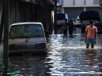 Residents of Kathmandu are wading through the floodwater along the embankment of the Bagmati River flowing through the capital after incessa...