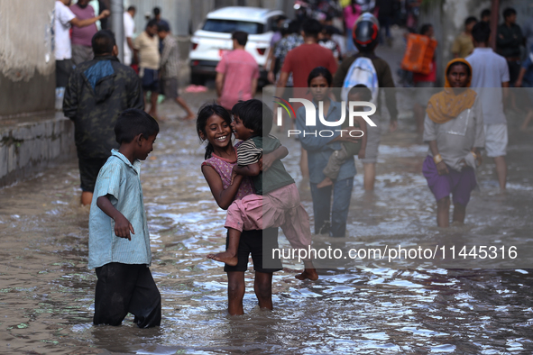 Residents of Kathmandu are wading through the floodwater along the embankment of the Bagmati River flowing through the capital after incessa...