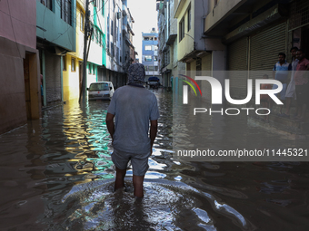 Residents of Kathmandu are wading through the floodwater along the embankment of the Bagmati River flowing through the capital after incessa...